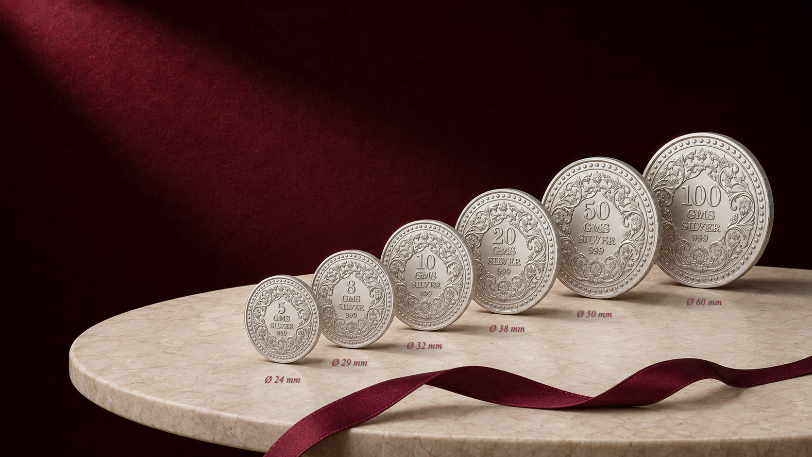Six House of Bhandari silver coins arranged by weight from 5 grams to 100 grams on limestone and velvet