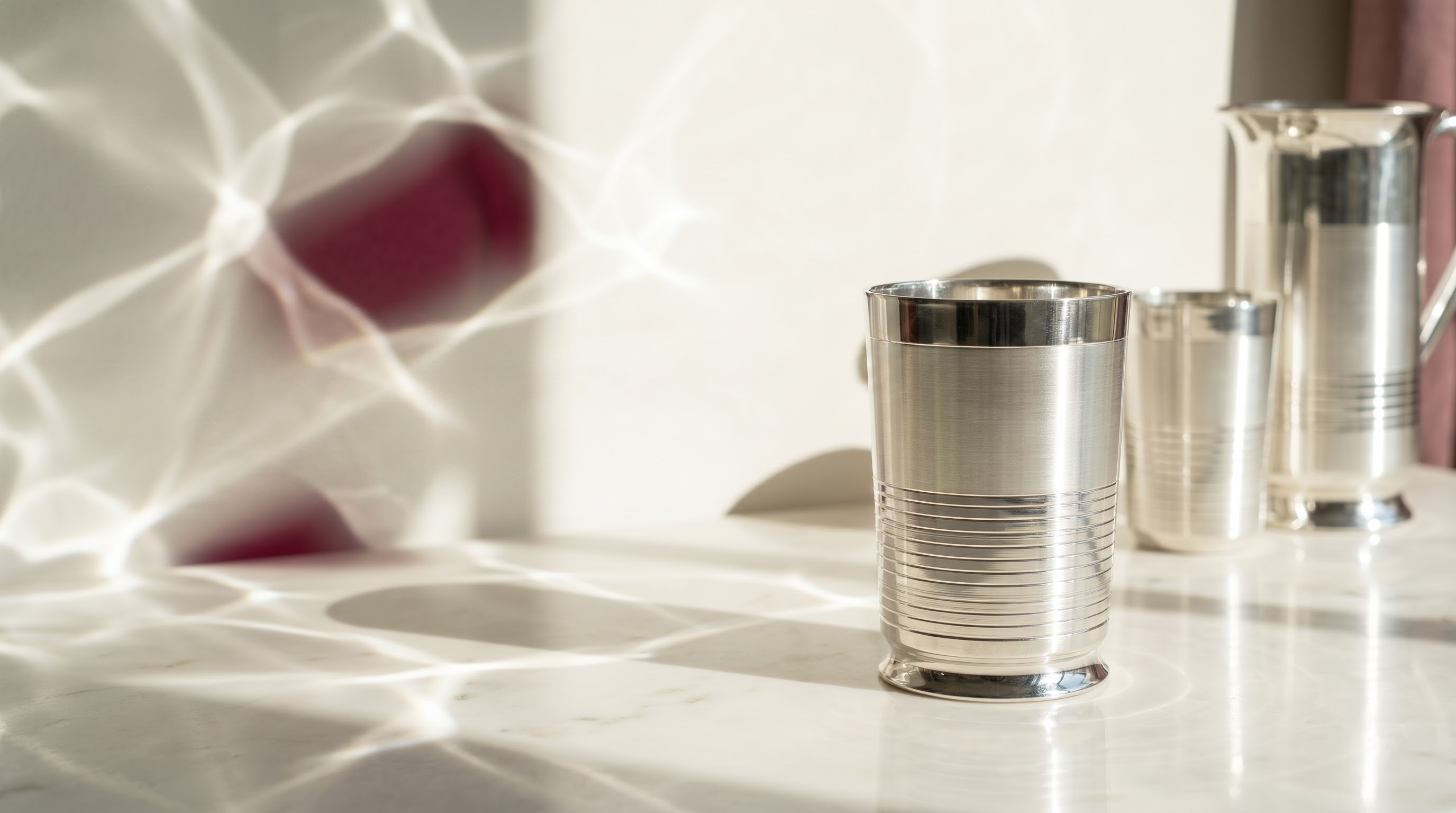 Silver tumbler in a considered tabletop scene